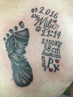 the back of a man's shoulder with his birth date and foot prints on it