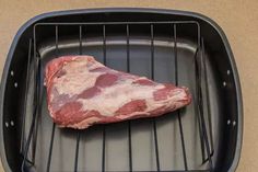 a piece of meat on top of a grill in a pan with it's lid open