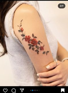 a woman with a rose tattoo on her arm