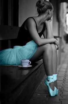 a black and white photo of a woman sitting on a bench with her legs crossed