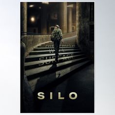 a man walking up some stairs in front of a building with the words silo on it