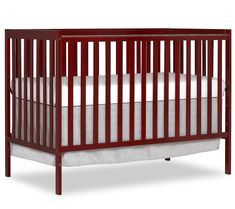 a baby crib that is red and has white sheets on the bottom half of it