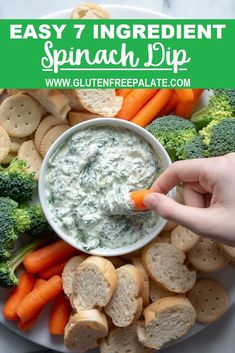 a plate with crackers, broccoli, carrots and dip on it