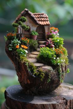 a small house made out of wood with plants and flowers growing on the top of it