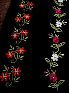 a black background with red and white flowers on it