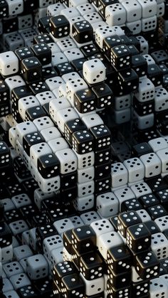 many black and white dices are stacked together