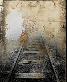 an old photograph of a train track in black and white, with the word's name on it