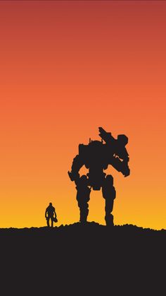 two people are standing in front of a giant robot on a hill with an orange and red sky behind them