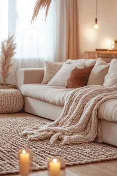 a living room filled with furniture and candles