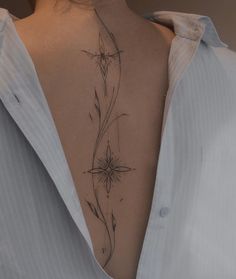 the back of a woman's neck with flowers on it