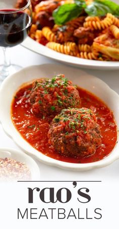 two plates with meatballs and pasta on them next to a glass of red wine