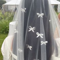 a woman wearing a veil with bows on it