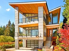 a two story house with lots of windows and balconies on the second floor