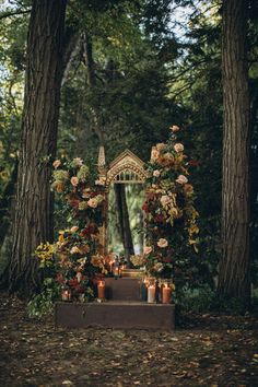 an outdoor altar surrounded by trees and candles