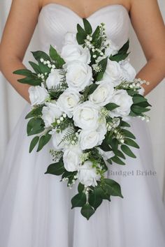 a bridal holding a bouquet of white flowers