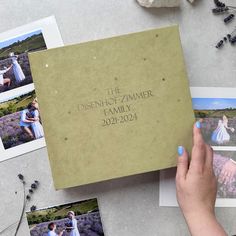 a person holding up a book with photos on it