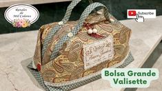 the purse is made out of fabric and has a tag on it that says bolsa grande valisette