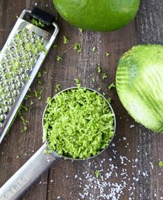 there are two limes and a grater next to each other on the table