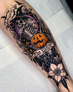 a person with a tattoo on their leg wearing a hat and holding a jack - o'- lantern