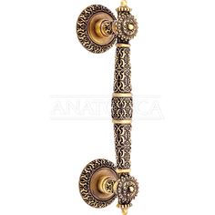 an ornate gold and black wall mounted hook