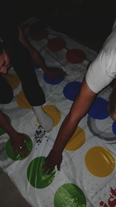 two people standing over a polka dot table cloth