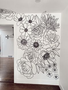 a wall with flowers drawn on it in a room