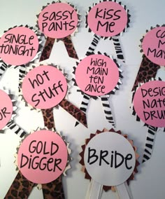 pink and black handmade badges with words on them that read, kiss me, not stuff, gold digger