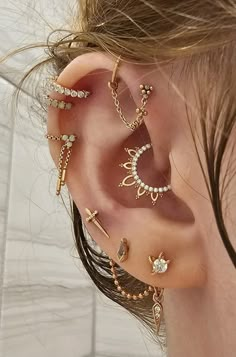 a woman wearing ear piercings with different designs