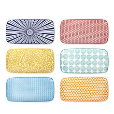 four placemats in different colors and patterns, one with an oval design on it