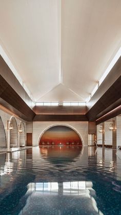 an indoor swimming pool in a large building