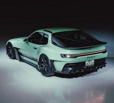 the rear end of a green sports car in a dimly lit room with its lights on