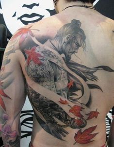 a man with tattoos on his back and chest