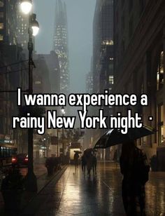 someone walking down the street with an umbrella in their hand and texting i wanna experience a rainy new york night