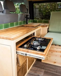 a stove top oven sitting inside of a camper