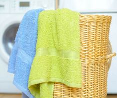 two towels are sitting in a wicker basket