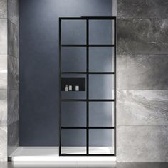 an empty bathroom with grey walls and marble flooring is seen in this image, there are shelves on either side of the shower