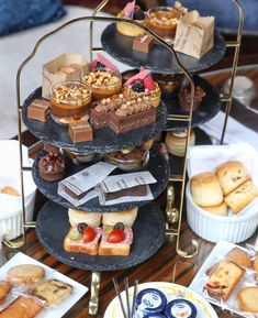 a table topped with lots of different types of desserts and pastries on trays