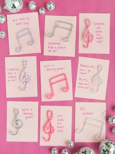 valentine's day cards with musical notes and beads on pink paper next to disco balls