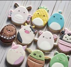 many decorated cookies are arranged in the shape of animals