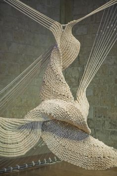 a sculpture made out of yarn hanging from strings