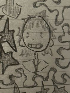 a drawing of a child's face on a piece of paper with numbers and stars