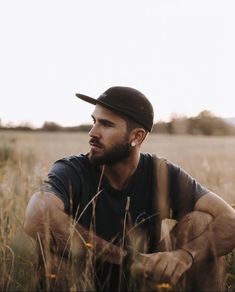 a man sitting in the middle of a field