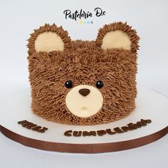 a teddy bear cake with chocolate frosting on it's face and the words congratulations written in large letters