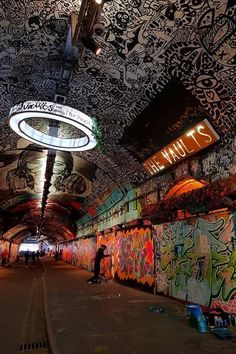 graffiti covered walls and ceilings in an underground subway station