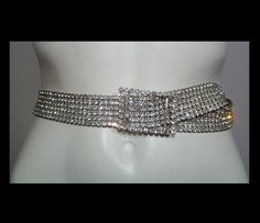 Hi!   Here's a gorgeous belt!   Very well made, the back side with the silver metal settings has lovely patina.     This belt has 6 rows of 5mm faceted clear rhinestones, all prong set. It fastens with a slide buckle.    Condition:   1 corner rhinestone is missing from the buckle, and 2 rhinestones missing from the end.   So glam!   Very fluid. Weight:  150 grams Width:   1 1/4" Length, end to end:   37.5" Buckle:   2 1/4" by 1 3/4" Diamond Belt, Disco Glam, Rhinestone Belt, Black And White Film, Studio 54, Gold Silk, Suspender Belt, Cotton Crochet, End To End