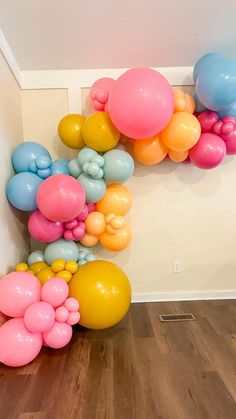 there are many balloons on the wall