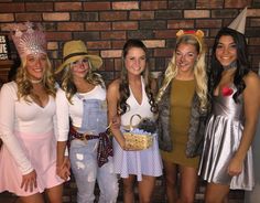 four women dressed up in costumes posing for the camera