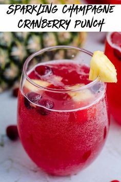 two glasses filled with red liquid next to pineapples and cranberry juice