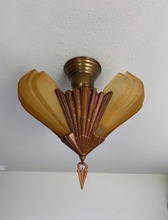 an art deco fan hanging from the ceiling