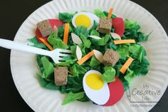 a paper plate topped with lettuce and eggs